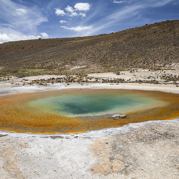 Photo of a hot spring in Peru with colorful thermophyllic algae